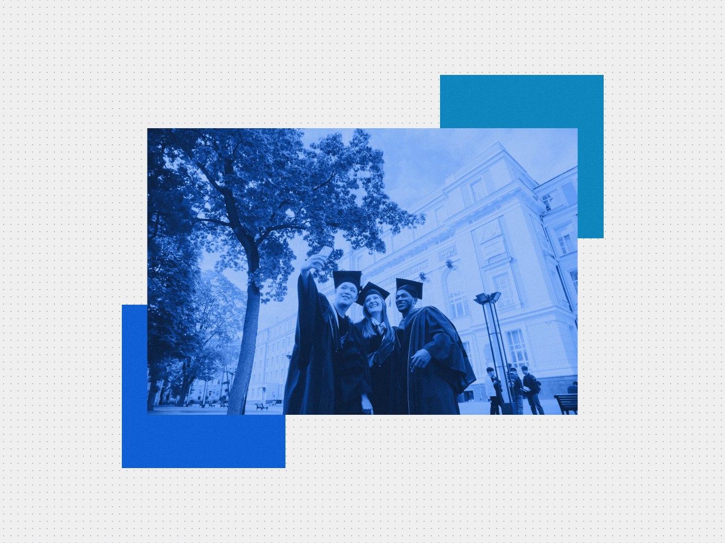Three university graduates taking a photo outside a campus building